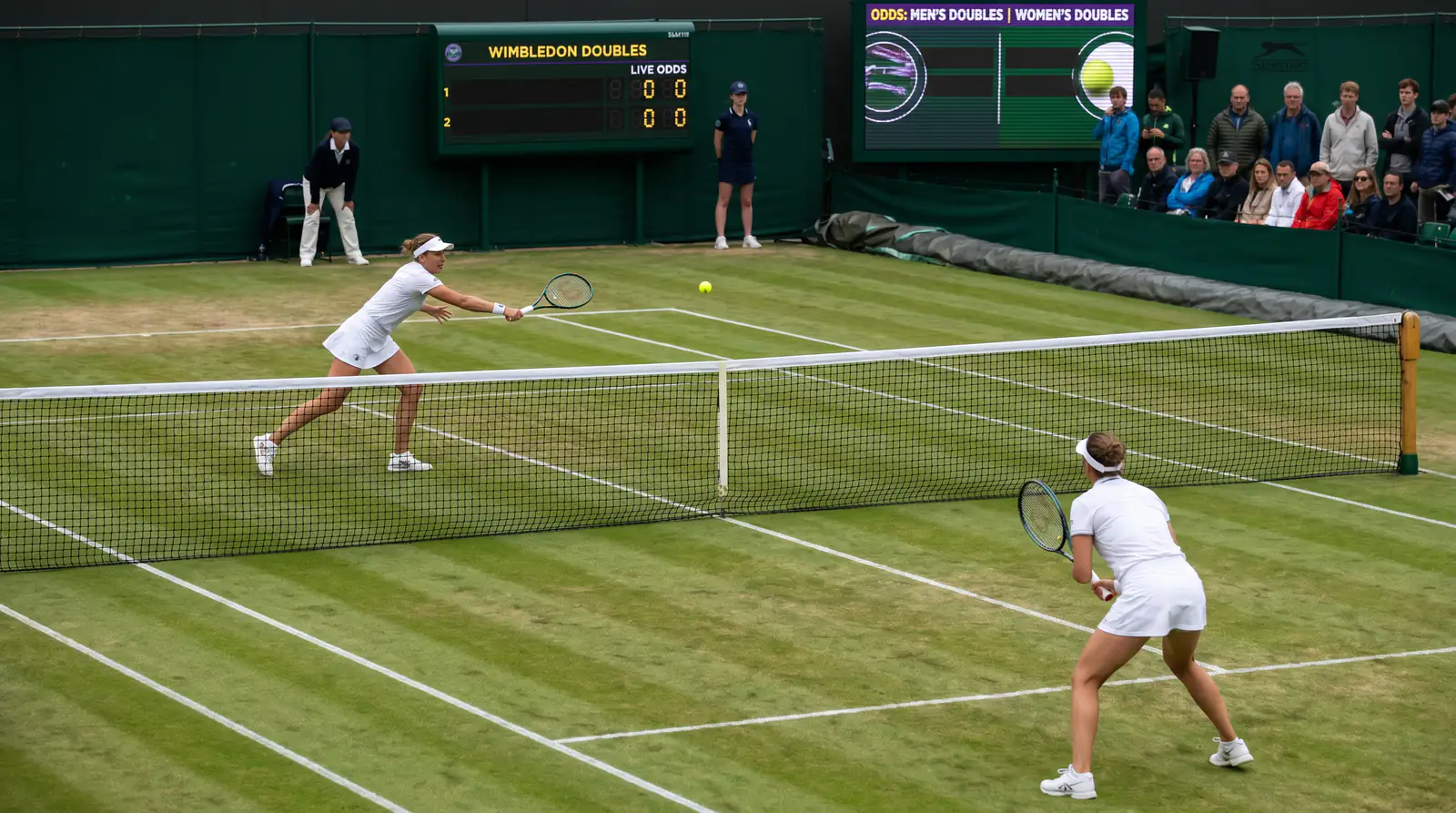 Wimbledon women's doubles partners playing at net on SW19 grass court